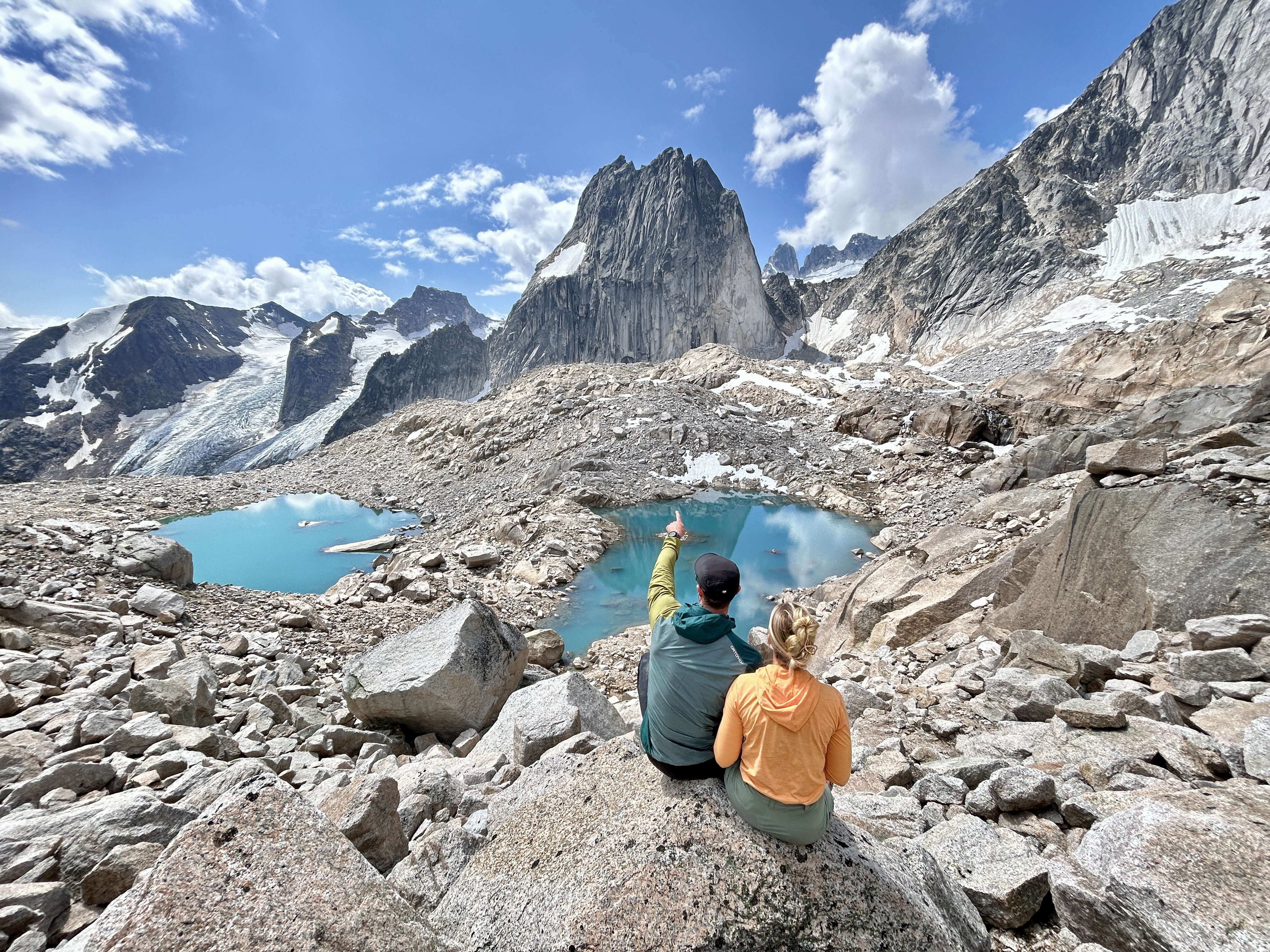 Two hikers at a glacial lake in the Purcell Mountains