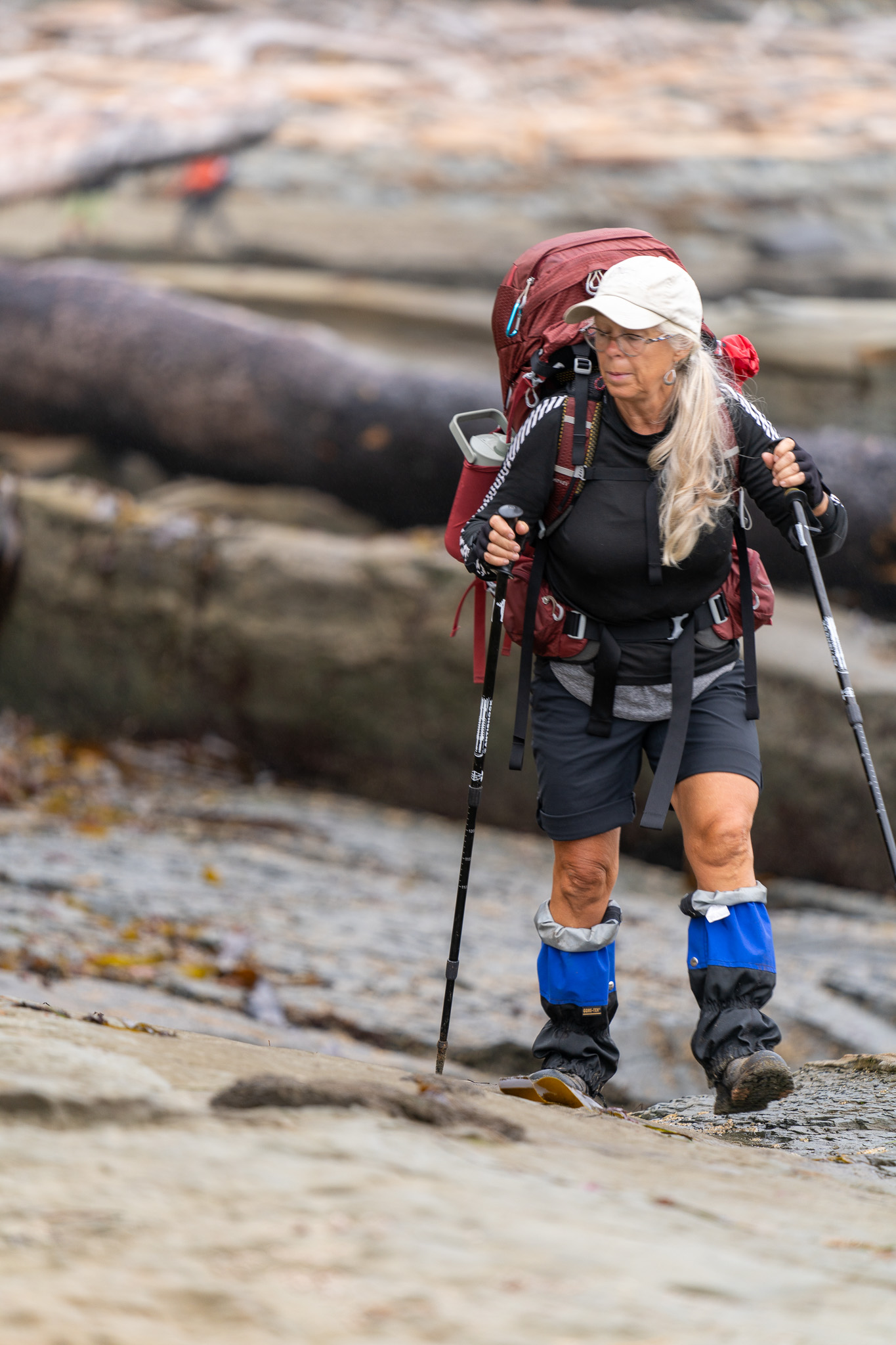 Experienced hiker with backpack on rocky terrain