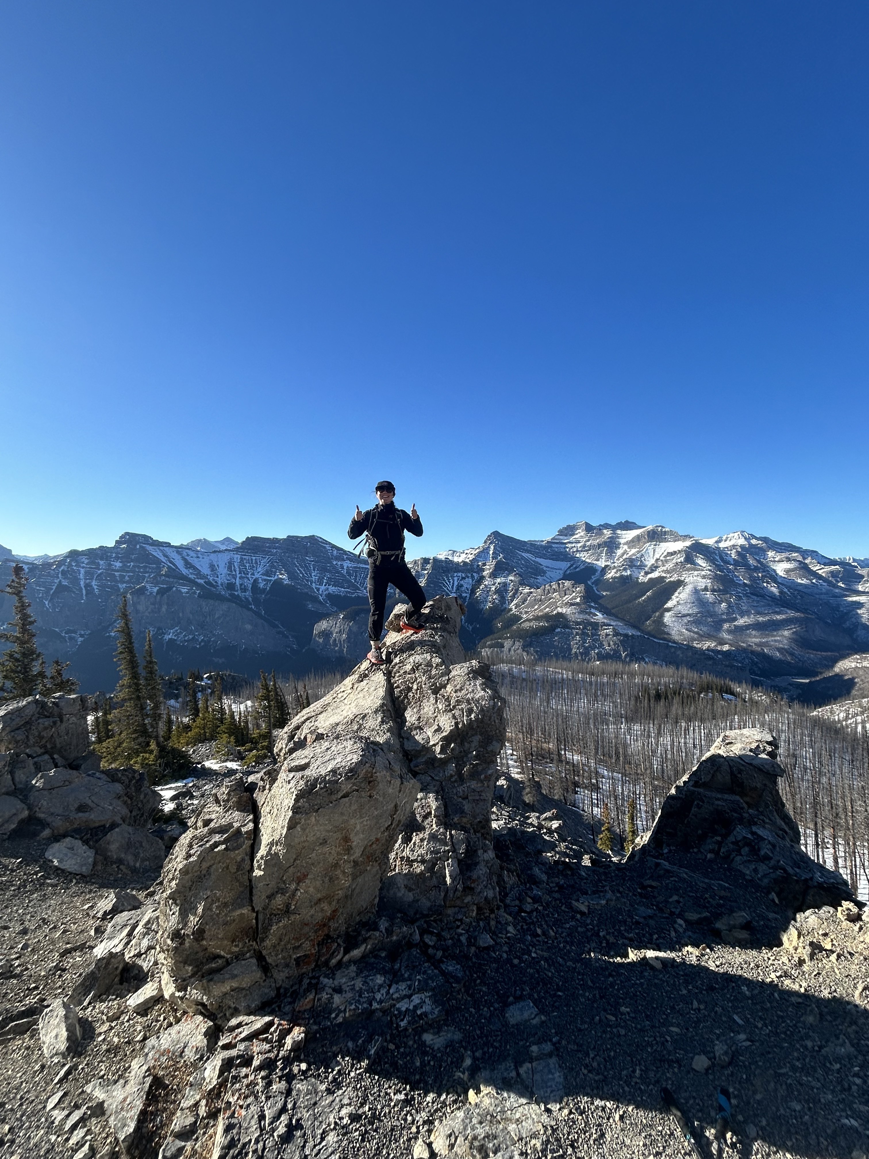 Two hikers on a mountain ridge with snow-capped peaks — Canadian Rockies